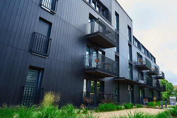 Modern architecture, residential area with modern apartment building with black facade