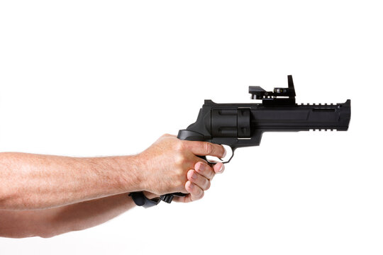 Hands Of Man Holding Gun Against White Background