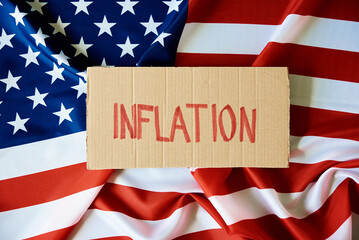 Fototapeta na wymiar Concept of recession and financial problem in USA banking system and world economic crisis,Cardboard with word recession against national american flag