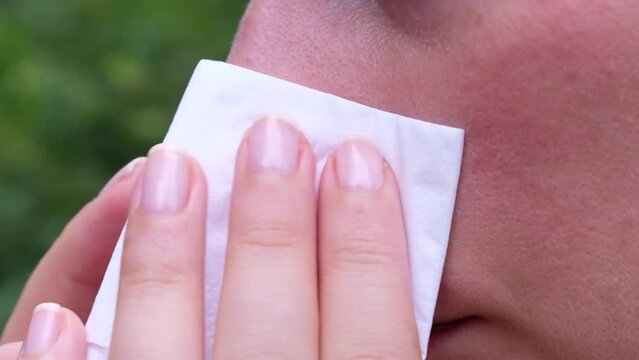 Woman suffering from hay and ambrosia allergy, red itchy nose