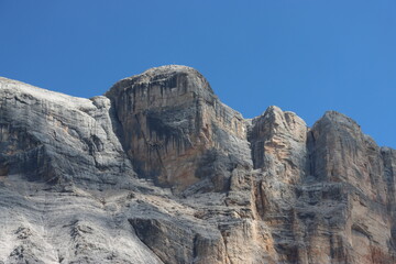 Val Badia, Italy-July 17, 2022: The italian Dolomites behind the small village of Corvara in summer days with beaitiful blue sky in the background. Green nature in the middle of the rocks.