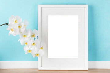 Elegant poster mockup,  orchid branch and white vertical picture frame with transparent background...