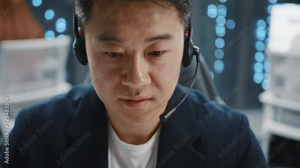 Wall mural face asian it developer administrator wearing headset speaker using laptop computer. server room tec