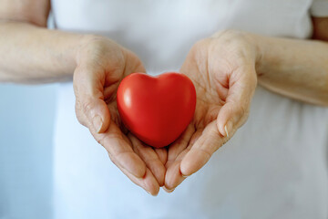 Grandmother woman hands holding red heart, healthcare, love, organ donation, mindfulness,...