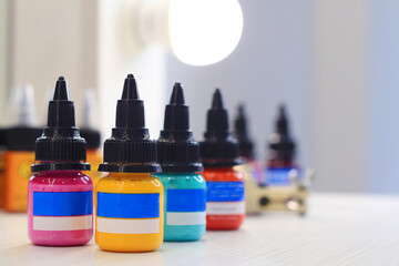 Bottles with inks for tattooing on table             