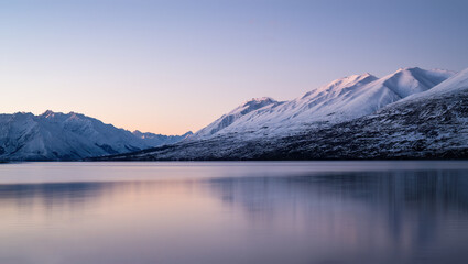 Snow-capped mountains reflected in Lake Ohau at sunset, Twizel, South Island.