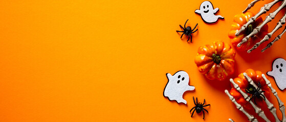 Halloween holiday banner design. Halloween decorations, ghosts, pumpkins, skeleton hands, spiders...