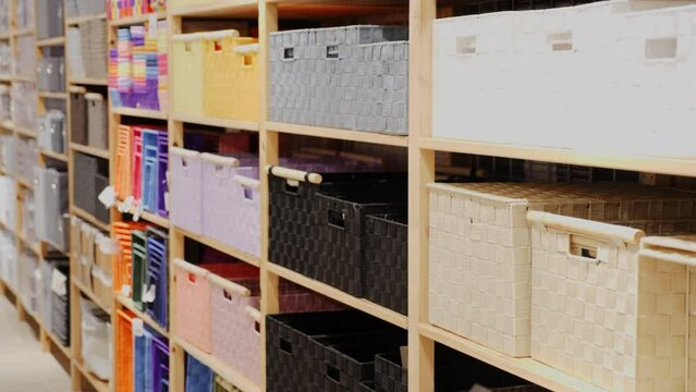 Focused African American looking for decorative boxes for storing household goods at store. Home improvement concept