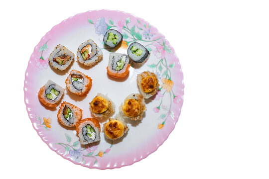 Varied Set Of Delicious Oriental Sushi Lounge On A Porcelain Ceramic Pink Plate