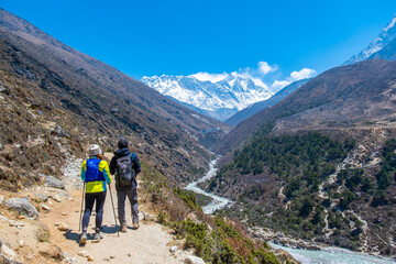 Fototapeta na wymiar A group of people trekking on dirt road in Nepal to Everest Base Camp