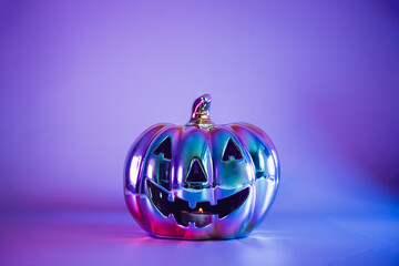 Spooky halloween pumpkin, Jack O Lantern, with an evil face and eyes made with holographic glass in...