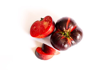 Fresh ripe black tomato isolated on a white background. Krim or Kumato tomatoes.