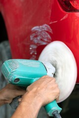 Hands-on close-up car body repair technician equipment for removing scratches Remove abnormal colors and polish colors.