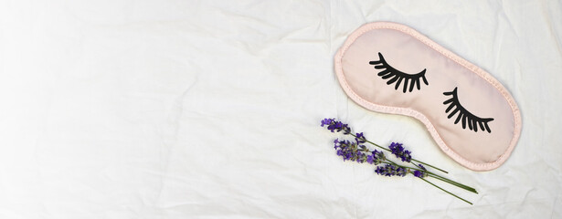 Sleep mask with natural lavender on a white sheet. Banner, flat lay, place for text.