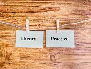 Theory and practice words . Wooden clothespins with green paper notes with  Words theory and...