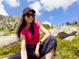 Naklejka na ściany i meble Happy Smiling Woman with hat and black sunglasses in the Mountain . Vitosha Mountain ,Bulgaria