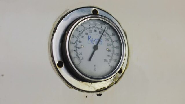 Pressure gauge in a factory, arrow movement on an industrial pressure gauge. Industrial pressure gauge