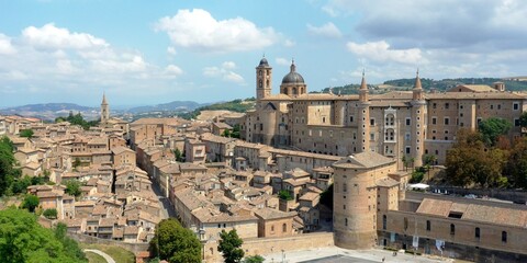 Fototapeta na wymiar Aerial view of Urbino with the Ducal Palace of Urbino built by Federico da Montefeltro in the center. Urbino, Pesaro and Urbino, Italy 