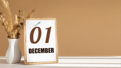 december 1. 1th day of month, calendar date.White vase with dead wood next to cork board with...