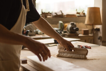 Close up of a carpenter working on a board