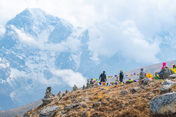 Trekkers And Colorful Prayer Flags