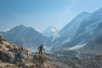 Male backpacker enjoying the view on mountain walk in Himalayas. Everest Base Camp trail route, Nepal trekking, Himalaya tourism. - obrazy, fototapety, plakaty