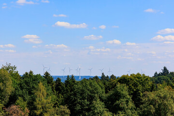 Obraz premium View over the forests in Rems-Murr district near Geildorf on the Swabian Alb in Germany to a wind farm with wind turbines