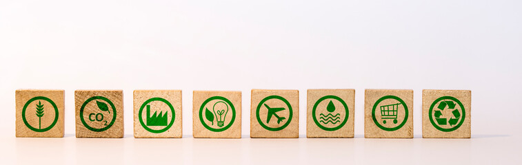 Green Icons for a supply chain and environmental friendliness and sustainability on wooden stones