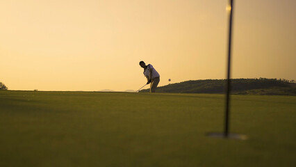 Professional Golfing in golf course chip shot hitting the golf ball for away from rough for on green, sports in holidays summer vacation at sunset golden time © Kiattisak
