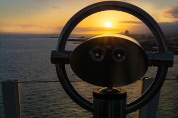 Binoculars on a cruise ship overlooking the sea at sunset