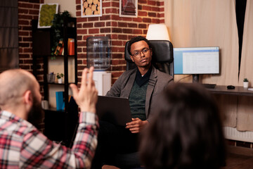 African american therapist listening to people at couple therapy session, doing psychoanalysis on...