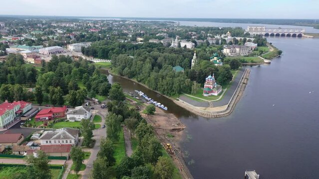 Picturesque aerial view of modern townscape of Uglich overlooking dam on Volga River on summer day, Yaroslavl region, Russia. High quality 4k footage