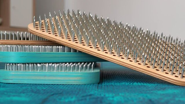 A set of sadhu boards laid out on the floor. Wooden natural and painted turquoise board sadhu. background movement. Concept for sadhu yoga practice