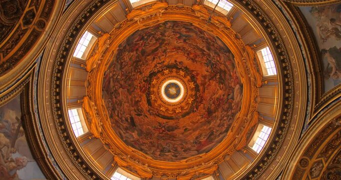 Looking Up On Frescoed Cupola Of Sant'Agnese in Piazza Navona, 17th-century Baroque Church In Rome, Italy. low angle spinning shot