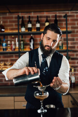 barman preparing cocktail in bar