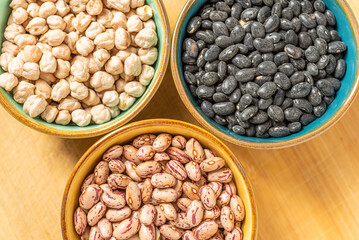 Dried Legumes In Bowls On Wooden Cutting Board.