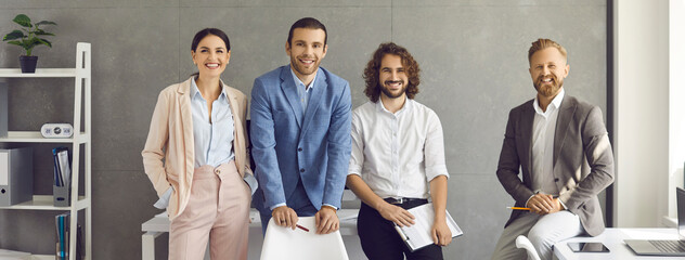 Group portrait of confident and successful colleagues or company executives in the office. Friendly...