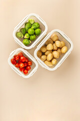 Glass boxes with fresh raw vegetables.  Vegetables and fruits in glass containers. Food storage concept