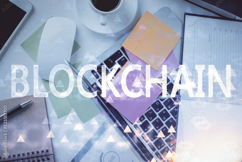 Poster Blockchain theme hologram drawings over computer on the desktop background. Top view. Multi exposure. Concept of cryptoeconomy.