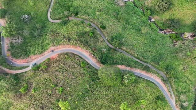Aerial Top Panning Shot Of Cars Moving On Mountain Road, Drone Flying Over Green Plants - Kandy, Sri Lanka