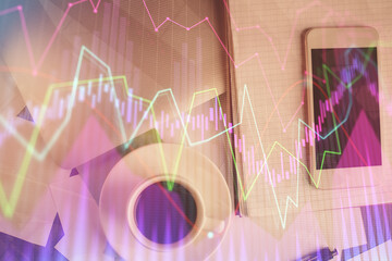 Multi exposure of forex graph hologram over desktop with phone. Top view. Mobile trade platform concept.