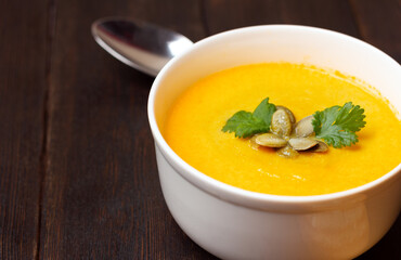 Pumpkin soup with seeds and parsley. Seasonal autumn food.