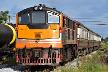 Fototapeta premium Passenger train by diesel locomotive on the railway
