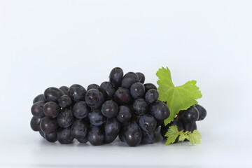 Red grapes on white background