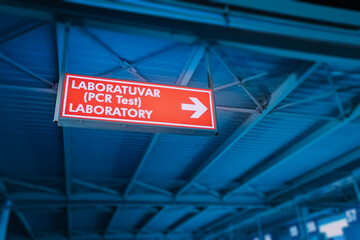 Sign with direction to PCR test laboratory in Turkish Airport. Coronavirus pandemic and infection
