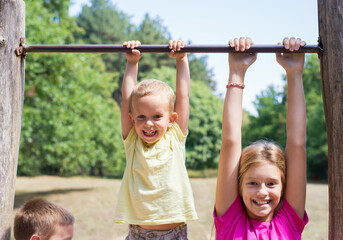 Fototapeta premium Children playing on the playground on a sunny summer day