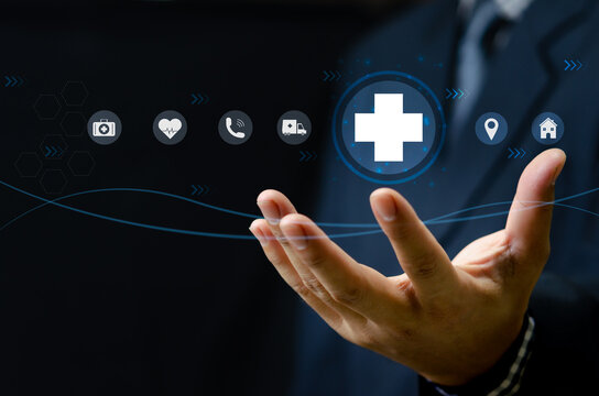 Man hand holding virtual medical health care icons with medical network connection.Business insurance.