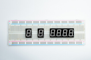 7-segment arduino indicators attached to a breadboard. Concept of a technical project. Selective focus. Background picture. Top view. 