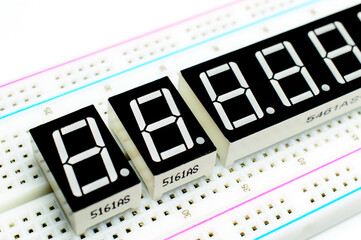 7-segment arduino indicators attached to a breadboard. Concept of a technical project. Selective focus. Background picture.