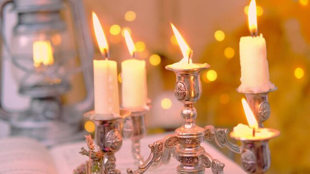school of wizards, burning candles in a candlestick, magical objects on an old wooden table in a dark room, an atmosphere of magic, the development of imagination, Halloween holiday